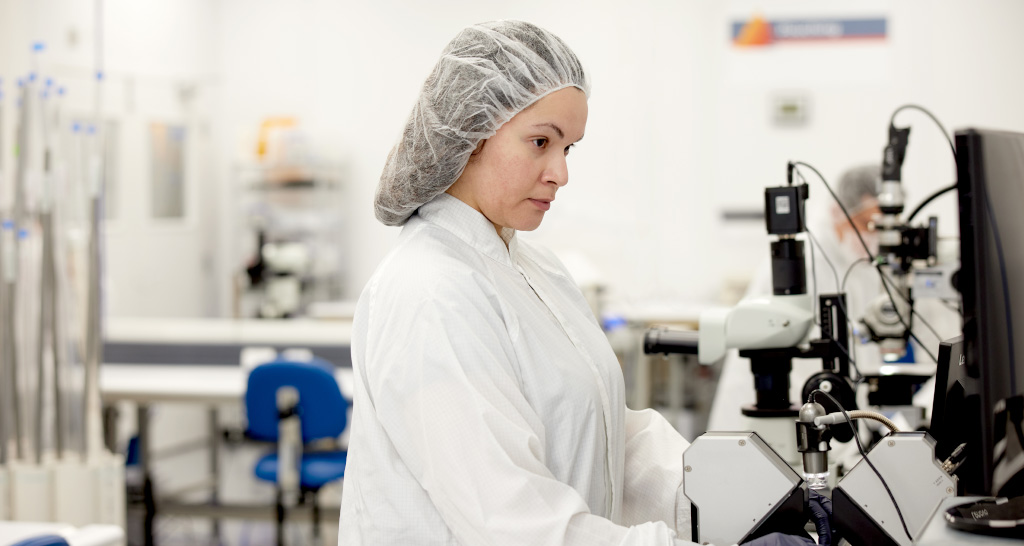 A TriSalus team member wearing PPE inspects the product in the lab.