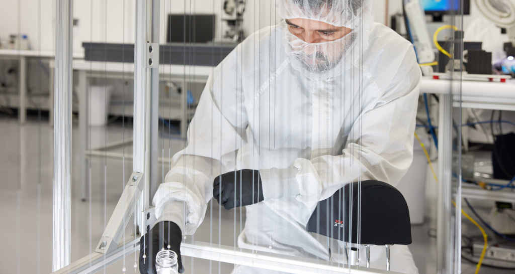 A member of the TriSalus team works in the lab wearing PPE.